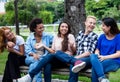 Group of chilling multi ethnic young adult people Royalty Free Stock Photo