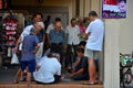 Group of Chinese men watch a game of checkers in Singapore neighborhood