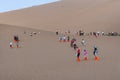 Group of Chinese tourists at the Crescent Moon Lake near the city of Dunhuang, in the Gansu Province, China. Royalty Free Stock Photo