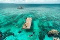 Group chinese tourists snorkeling in turquoise sea about rocky coast of the Crystal Cove island near Boracay