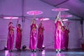 A group of Chinese women performing an umbrella dance on stage Royalty Free Stock Photo