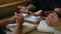 Group of christian people reading and study bible in home and pray together.Group of people holding hands praying worship god. Royalty Free Stock Photo