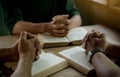 Group of christian people reading and study bible in home and pray together.Group of people holding hands praying worship god. Royalty Free Stock Photo