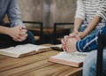 group of christian sitting around wooden table and pray together Royalty Free Stock Photo