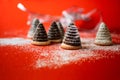 Group of christmas beehive cake on snowy red background with blurred silver ribbon
