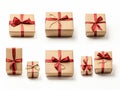 group of Christmas gift packages with red ribbon on cut out white background three-quarter view