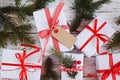 Group Christmas white gift boxes with red ribbons on white table. Top view