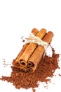 Group of cinnamon sticks on cacao powder, isolated on white background. Royalty Free Stock Photo