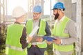 Small group of architects discussing project details and checking work progress Royalty Free Stock Photo