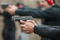 Group of civilian practice gun shooting on outdoor shooting range Royalty Free Stock Photo