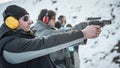 Group of civilian practice gun shooting on outdoor shooting range Royalty Free Stock Photo