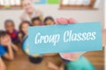 Group classes against cute pupils and teacher in classroom with globe