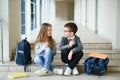 Group of classmates having lunch during break with focus on smiling girl with apple Royalty Free Stock Photo