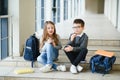 Group of classmates having lunch during break with focus on smiling girl with apple. Royalty Free Stock Photo