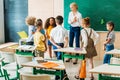 group of classmates standing around teacher