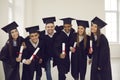 Group of classmates university graduates feeling happy with successful getting diplomas Royalty Free Stock Photo