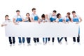 Group of cleaners holding a blank white banner Royalty Free Stock Photo
