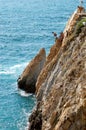 Group of cliff divers in free fly, Acapulco, Mexico. Royalty Free Stock Photo