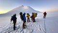 A group of climbers against the background of Mount Kazbek at sunrise