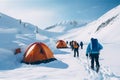 A group of climbers in an alpine camp with tents on a mountain peak. Royalty Free Stock Photo