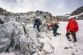 Group of climbers ascent to the mountain on a complex slope is composed of rock and snow Royalty Free Stock Photo