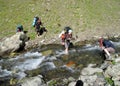 Group of climbers crossing river