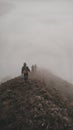 Group of climbers going down mountain ridge surrounded by fog.  27 March 2022, Gowa, Indonesia. Royalty Free Stock Photo