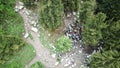 A group of climbers stopped in the woods to rest. View from the drone.