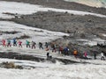 Group of climbers with trekking poles climbs Mount Elbrus