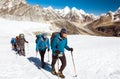 Group of Climbers walking on Glacier in high Mountains