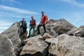 A group of climbing friends, smiling and looking at the camera at the top of the rock Royalty Free Stock Photo