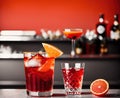 A group of cocktails on a bar with orange slices and olives. Royalty Free Stock Photo