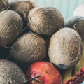 Group of coconuts and pomegranates in a basket for offerings to
