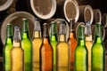 Group of cold wet beer bottles in the cellar with vintage kegs Royalty Free Stock Photo