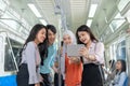 Group of colleagues viewing digital content from a tablet on their way to work