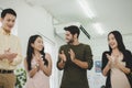 Group of colleagues young business people in smart casual clapping and brainstorm planning new project Royalty Free Stock Photo