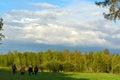 A group of collectors of men and women Asian Yakuts with bags and buckets are on the North field at sunset in the evening in the s