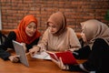 Group of college student, friends with digital tablet and carrying a books