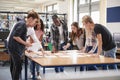 Group Of College Students Collaborating On Project In Library