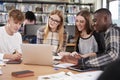 Group Of College Students Collaborating On Project In Library Royalty Free Stock Photo