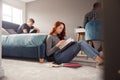 Group Of College Students In Shared House Bedroom Studying Together