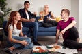 Group Of College Students In Shared House Having Night In Eating Pizza Together Royalty Free Stock Photo