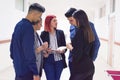 Group of college students standing in corridor and chatting after their class. Group of college students talking and laughing Royalty Free Stock Photo
