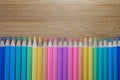 Group of color pencild laying in row striaght line made by pencil tips on wooden table background close up, Color pancils, copy Royalty Free Stock Photo