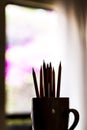 A group of color pencils forming a silhouette in a white cup Royalty Free Stock Photo