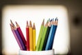 A group of color pencils in a white cup Royalty Free Stock Photo