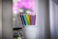 A group of color pencils in a white cup Royalty Free Stock Photo