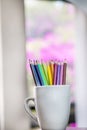 A group of color pencils in a white cup Royalty Free Stock Photo