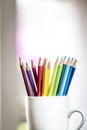 A group of color pencils in a white cup Royalty Free Stock Photo