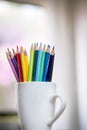 A group of color pencils in a white cup Royalty Free Stock Photo